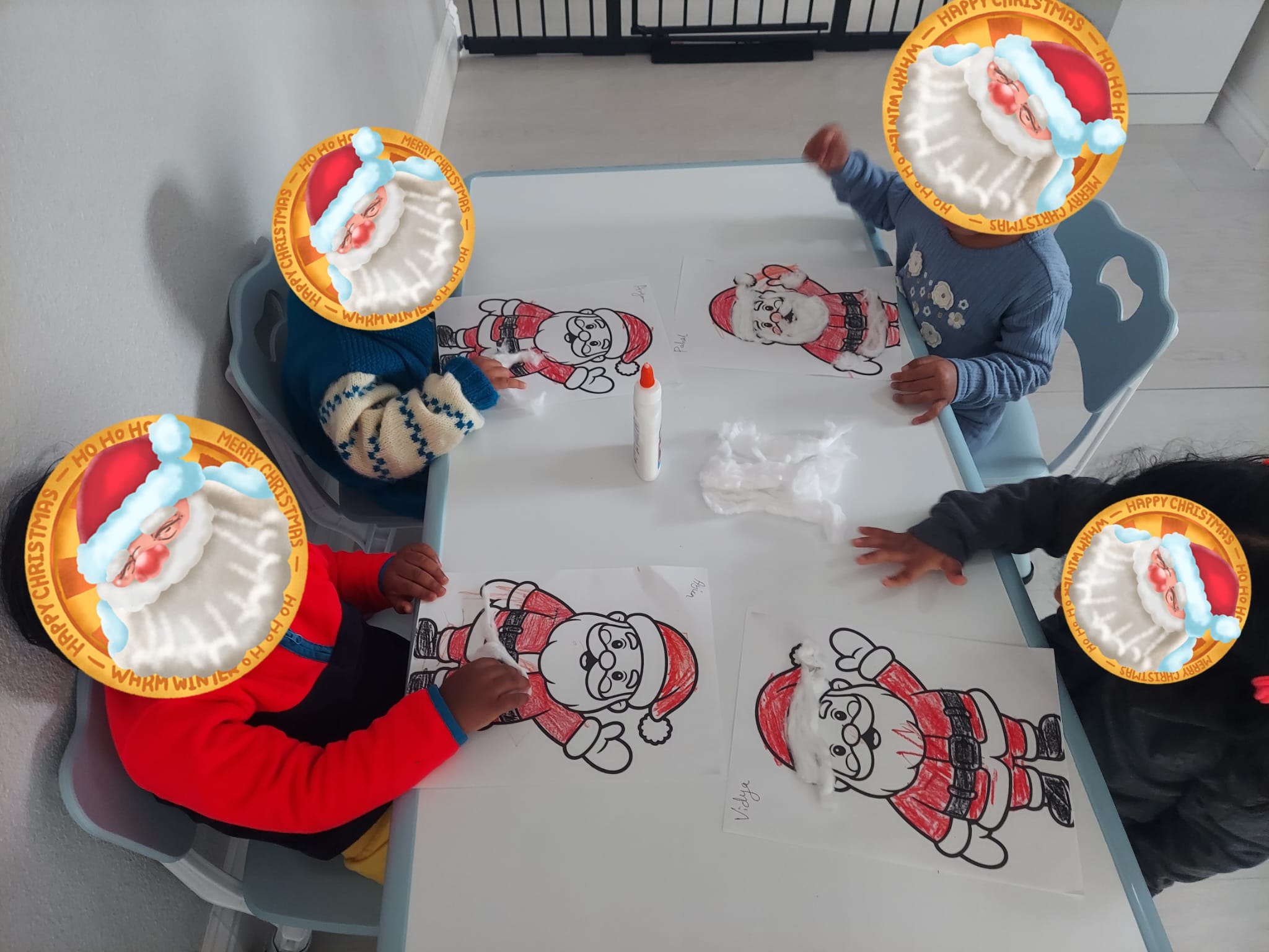 Children coloring holiday pictures together at a table