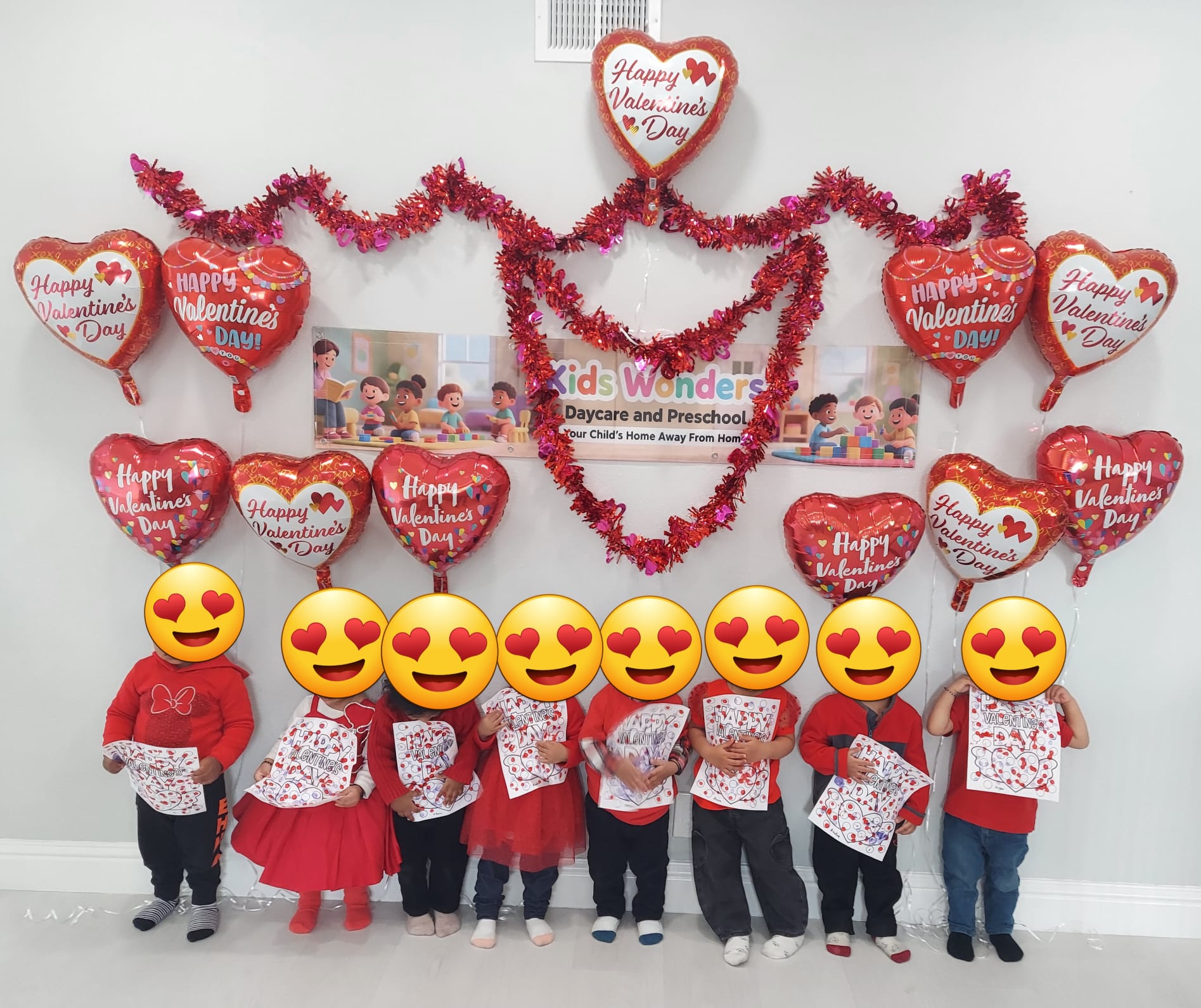Children celebrating Valentine's Day with classroom artwork